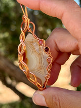 Load image into Gallery viewer, Artisan cab (positive rocks) orange botswana agate with sunstone + garnet gem accent wire wrapped pendant necklace