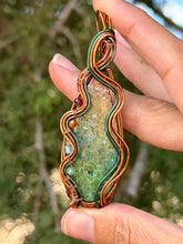 Load image into Gallery viewer, artisan cab (positive rock) rainbow fossilized palm root with garnet, carnelian, blue topaz, peridot gem accent wire wrapped pendant necklace