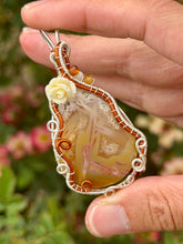 Load image into Gallery viewer, Artisan cab (positive rocks) orange tube agate with dandelion + moonstone gem accents wire wrapped pendant necklace