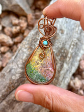 Load image into Gallery viewer, Artisan cab (positive rocks) rainbow fossilized palm root with turquoise gem accent wire wrapped pendant necklace