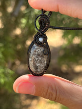 Load image into Gallery viewer, Black fossilized coral with mother of pearl gem accent wire wrapped pendant necklace