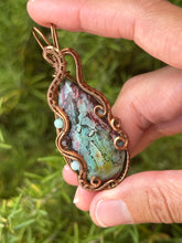 Load image into Gallery viewer, Artisan cab (positive rocks) rainbow fossilized palm root with garnet + amazonite gem accents wire wrapped pendant necklace