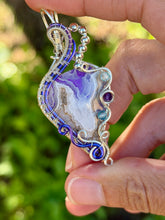 Load image into Gallery viewer, Artisan cab (positive rock) purple aurora opal plume agate doublet with amethyst, blue topaz gem accents wire wrapped pendant necklace