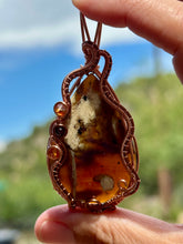 Load image into Gallery viewer, Indonesian (UV REACTIVE) Amber with carnelian + garnet gem accents wire wrapped pendant necklace