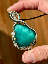 Load image into Gallery viewer, Reserved for Sheena h DUO TONED WIRE Emerald Mona Lisa cat’s eye with quartz + turquoise inclusions Wire wrapped pendant

