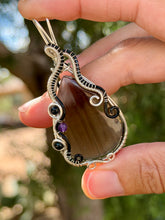 Load image into Gallery viewer, Artisan cab (positive rock) black lace obsidian with blue tiger eye + amethyst gem accent wire wrapped pendant necklace
