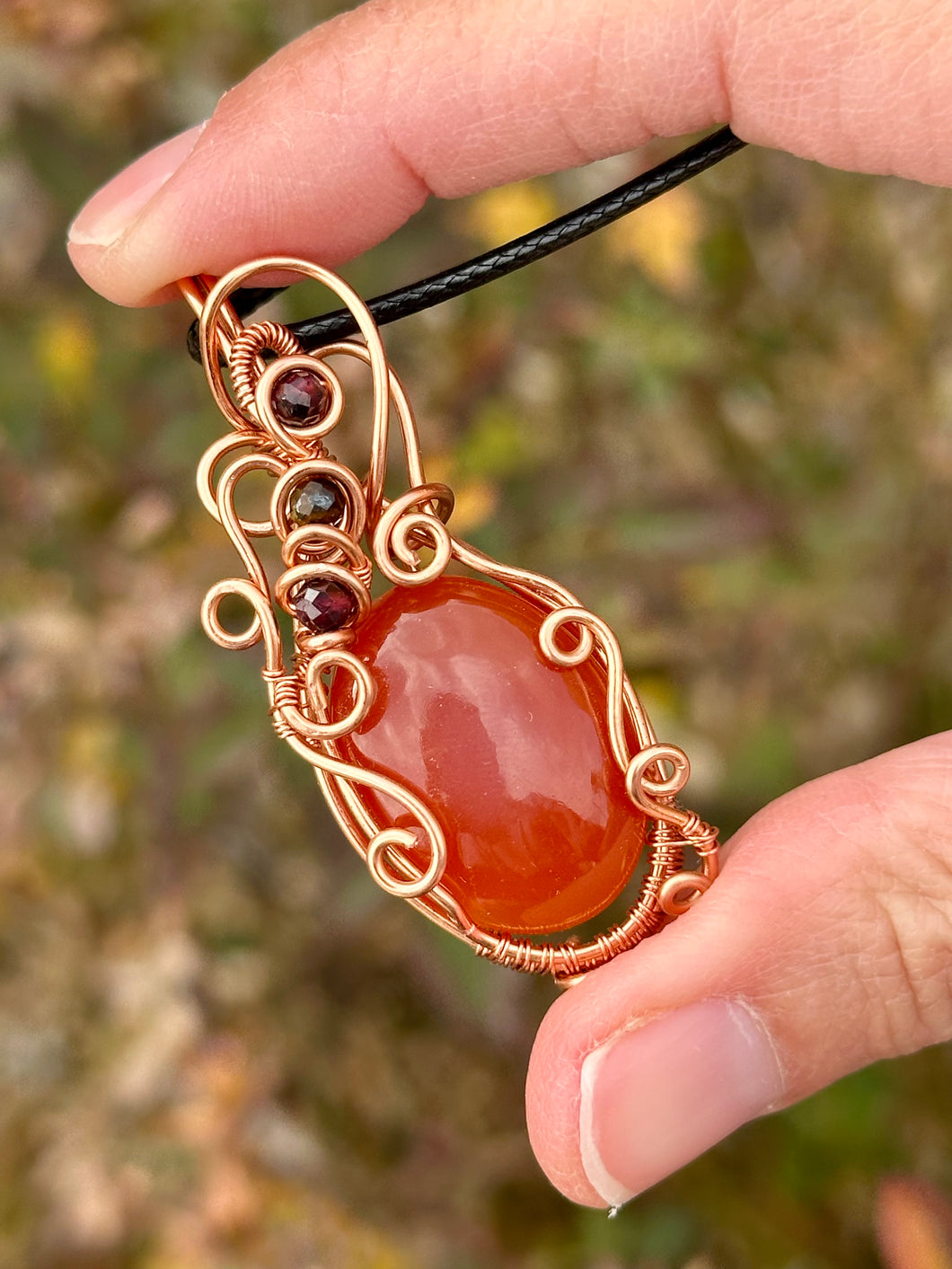 Carnelian with tigers eye + garnet inclusions Wire wrapped pendant