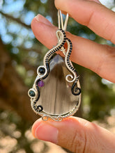 Load image into Gallery viewer, Artisan cab (positive rock) black lace obsidian with blue tiger eye + amethyst gem accent wire wrapped pendant necklace
