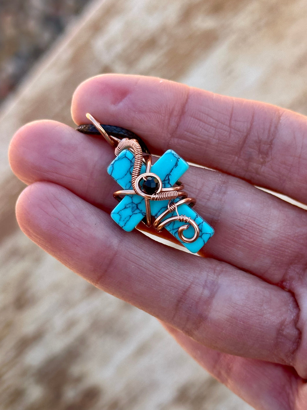 Blue (dyed) magnesite cross with black spinel  Wire wrapped pendant