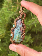 Load image into Gallery viewer, Artisan cab (positive rocks) rainbow fossilized palm root with garnet + amazonite gem accents wire wrapped pendant necklace
