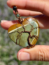 Load image into Gallery viewer, Artisan cab (positive rock) polychrome desert jasper with green tourmaline + blue tiger eye gem accents tree of life wrap wire wrapped pendant necklace
