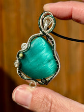 Load image into Gallery viewer, Reserved for Sheena h DUO TONED WIRE Emerald Mona Lisa cat’s eye with quartz + turquoise inclusions Wire wrapped pendant
