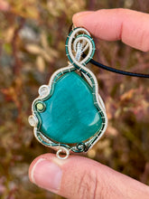 Load image into Gallery viewer, Reserved for Sheena h DUO TONED WIRE Emerald Mona Lisa cat’s eye with quartz + turquoise inclusions Wire wrapped pendant
