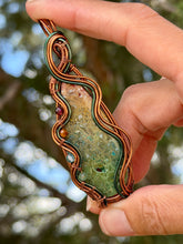 Load image into Gallery viewer, artisan cab (positive rock) rainbow fossilized palm root with garnet, carnelian, blue topaz, peridot gem accent wire wrapped pendant necklace

