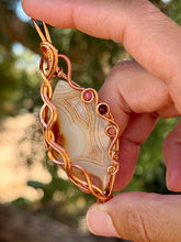 Load image into Gallery viewer, Artisan cab (positive rocks) orange botswana agate with sunstone + garnet gem accent wire wrapped pendant necklace
