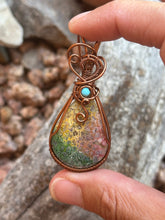 Load image into Gallery viewer, Artisan cab (positive rocks) rainbow fossilized palm root with turquoise gem accent wire wrapped pendant necklace
