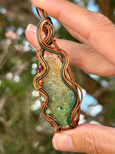 Load image into Gallery viewer, artisan cab (positive rock) rainbow fossilized palm root with garnet, carnelian, blue topaz, peridot gem accent wire wrapped pendant necklace
