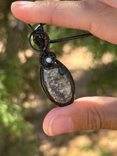 Load image into Gallery viewer, Black fossilized coral with mother of pearl gem accent wire wrapped pendant necklace
