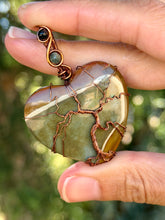 Load image into Gallery viewer, Artisan cab (positive rock) polychrome desert jasper with green tourmaline + blue tiger eye gem accents tree of life wrap wire wrapped pendant necklace
