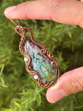 Load image into Gallery viewer, Artisan cab (positive rocks) rainbow fossilized palm root with garnet + amazonite gem accents wire wrapped pendant necklace

