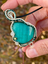Load image into Gallery viewer, Reserved for Sheena h DUO TONED WIRE Emerald Mona Lisa cat’s eye with quartz + turquoise inclusions Wire wrapped pendant

