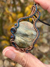 Load image into Gallery viewer, Reserved for ann c DUO TONED WIRE + DESIGNER CAB common blue opal with petrified wood with lapis lazuli + garnet inclusions Wire wrapped pendant
