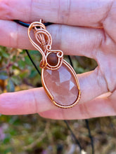 Load image into Gallery viewer, Faceted peach moonstone with amber gem inclusions wire wrapped pendant necklace
