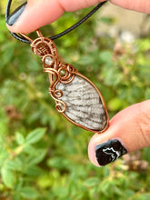 Load image into Gallery viewer, Fossilized black coral with green fluorite + peridot gem inclusions wire wrapped pendant necklace
