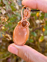 Load image into Gallery viewer, Faceted peach moonstone with amber gem inclusions wire wrapped pendant necklace
