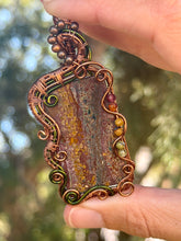 Load image into Gallery viewer, Artisan cab (positive rock) Scenic Plume Jasper with Garnet, Orange Garnet, Yellow Mookaite, Tiger Eye, Serpentine + Peridot Gem Accents wire wrapped pendant necklace
