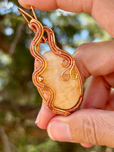 Load image into Gallery viewer, Orange calcite with sunstone + hematite gem accents wire wrapped pendant necklace
