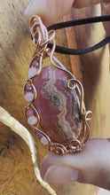 Load and play video in Gallery viewer, Reserved for jenni p Rhodochrosite with gem inclusions Wire Wrapped Pendent Necklacete
